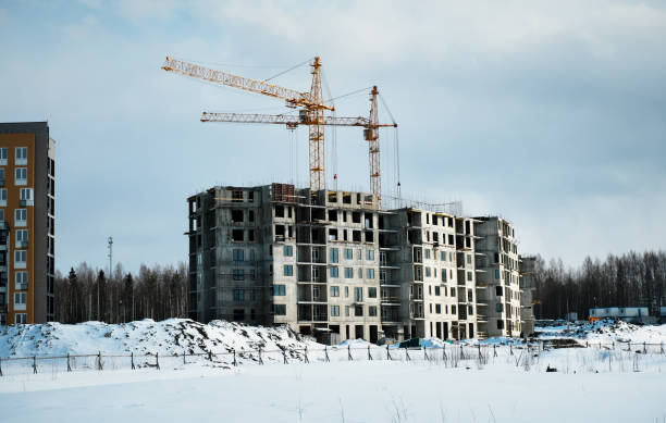 istock Crane and unfinished house. Building construction in winter 1394125448