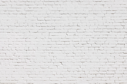 Old but freshly painted white brick wall.
