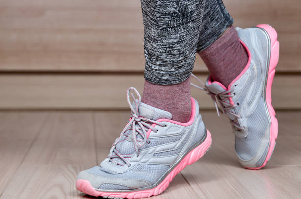 istock Fit female leg in sport shoe step 1394126794