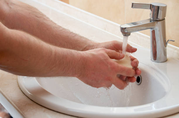 istock Closeup image of man washing hands in bathroom 1394126804