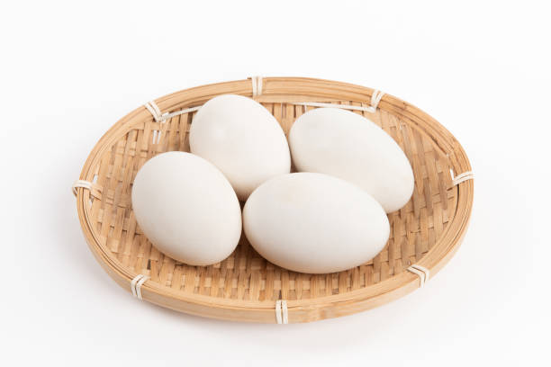 istock Fresh goose eggs in a rattan basket on wooden table 1394132691