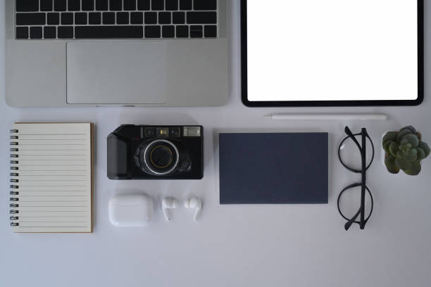 istock Flat lay designer workplace with digital tablet, camera, laptop, notebook and glasses. 1394132999