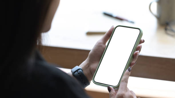 istock Close up view woman hands holding smart phone with empty screen for advertise text. 1394133112