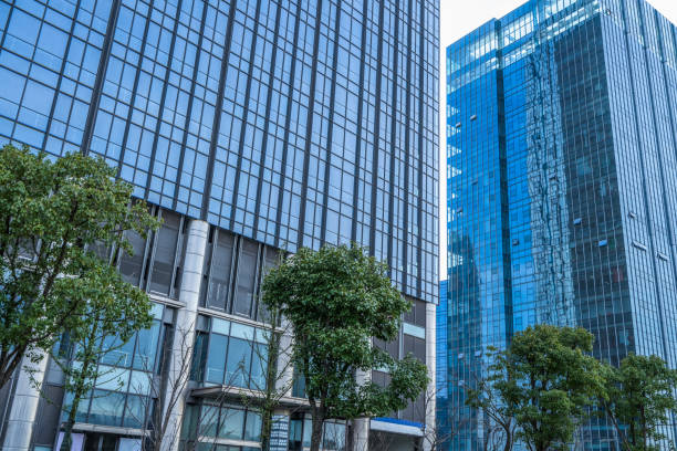 istock modern office building with green trees 1394133259