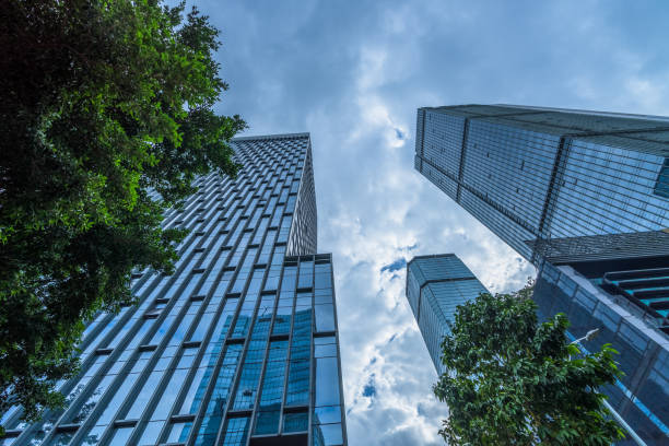 istock modern office building with green trees 1394133880