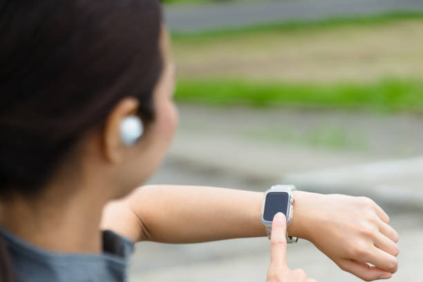 istock woman running looking at a smartwatch 1394133918