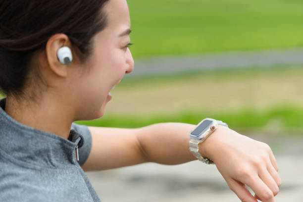 istock woman running while looking at a smartwatch (voice operation) 1394134244