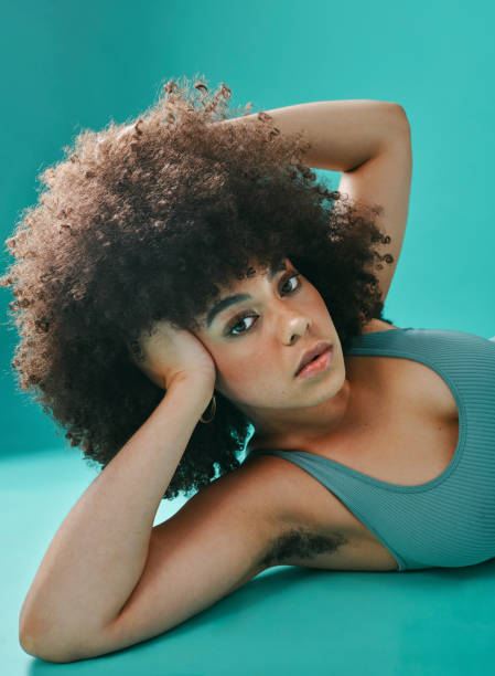 istock Mixed race woman lying and posing in the studio 1394135142