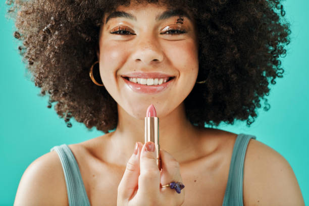 istock Afro model holding lipstick in the studio 1394135154