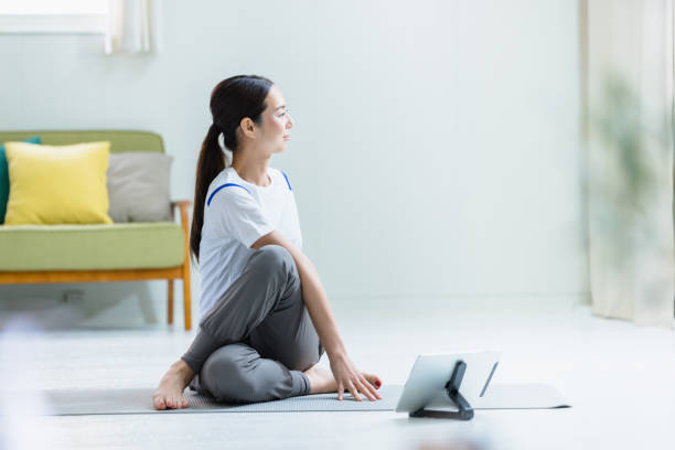 Image of women's home fitness Image of women's home fitness online yoga stock pictures, royalty-free photos & images