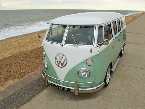 Side view of a cream coloured vintage Morris Minor. The cars were designed in the UK, and produced from 1948 to 1971.