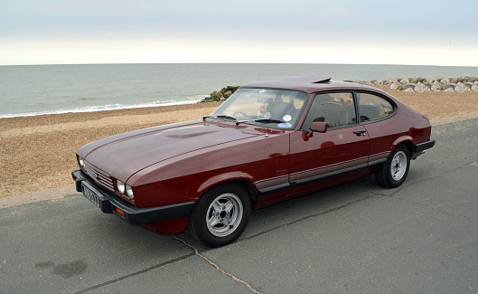 Felixstowe, Suffolk, England - August 27, 2016: Classic Dark Red Ford Capri Motor Car parked on seafront promenade.