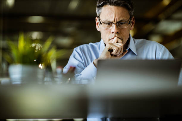 istock Worried entrepreneur reading an e-mail on laptop in the office. 1394138374