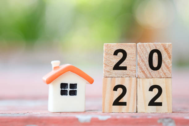 istock 2022 wooden blocks number  and mini house model. 1394139801