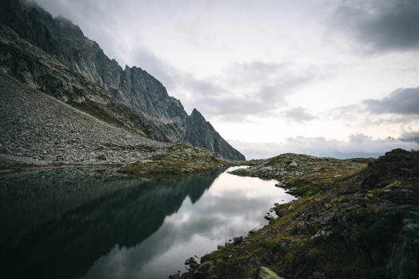 Mountain ranges reflect in the lakeshore below