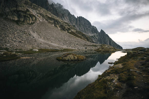 Mountain ranges reflect in the lakeshore below