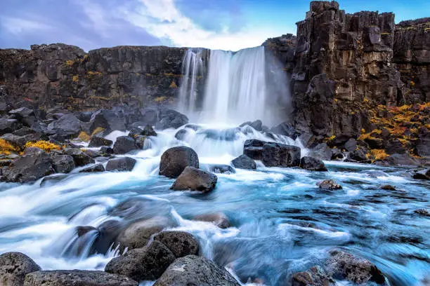 Photo of Oxarafoss, or the waterfall in the Ax River, in the Thingvellir national park, Iceland in autumn