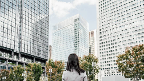 istock woman in a suit in an office district (business image) 1394145536