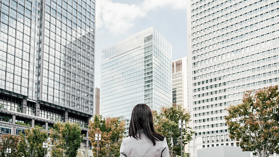 woman in a suit in an office district (business image)