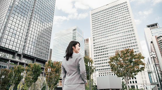 woman in a suit in an office district (business image)
