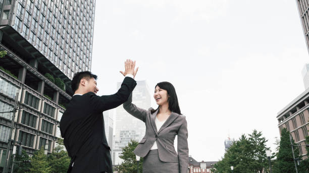 istock Men and women with high five (business image) 1394145546