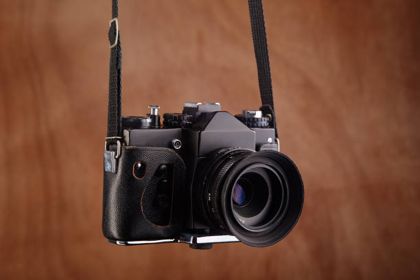 istock SLR Single-lens reflex professional film camera hanging on its strap 1394146111