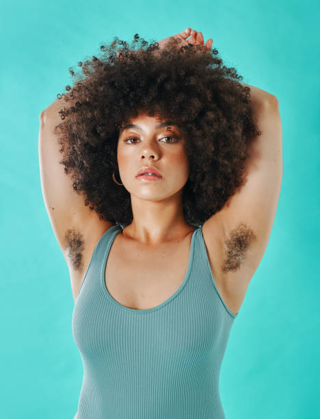 Mixed race woman showing armpit hair in the studio Mixed race woman showing armpit hair in the studio body hair stock pictures, royalty-free photos & images