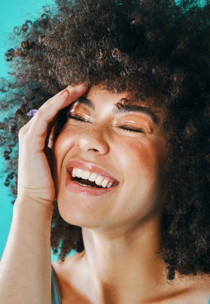 istock Mixed race model with afro laughing in the studio 1394147473