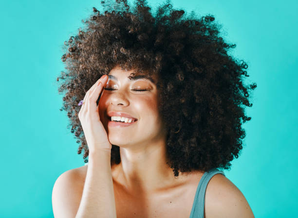 istock Mixed race model with afro laughing in the studio 1394147474