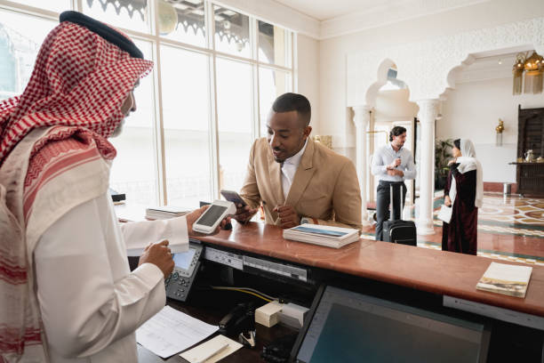 istock Black businessman making contactless payment at Riyadh hotel 1394149723