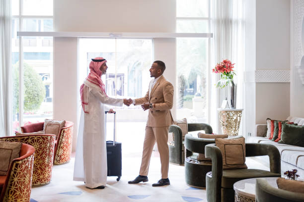 Saudi associates shaking hands in lounge of Riyadh hotel