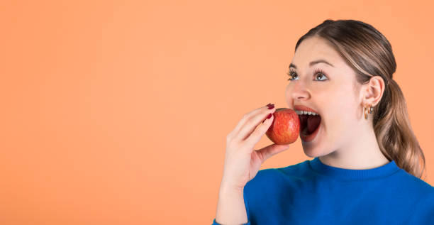 istock Woman eating an apple. 1394150060