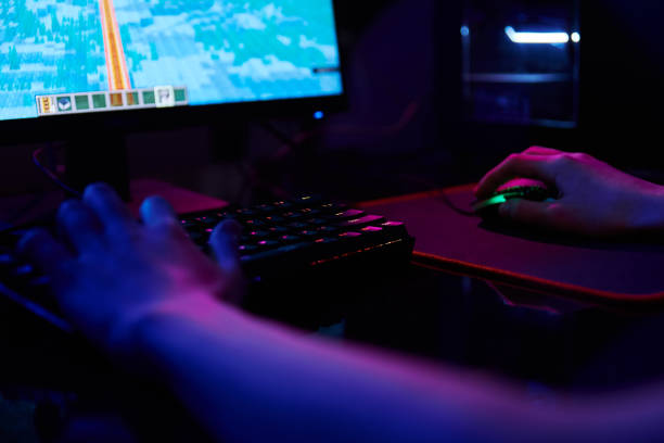istock Gamer play computer game, use rgb neon colored keyboard 1394152846