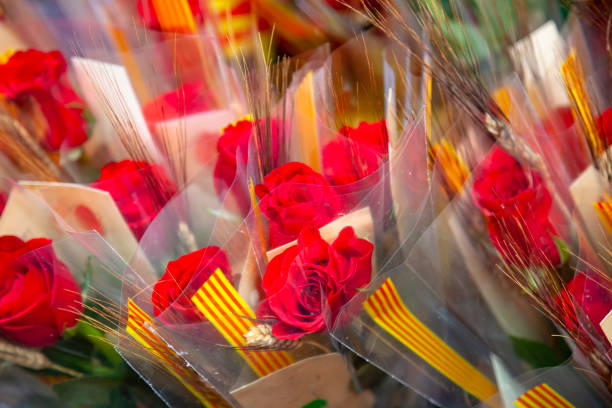 A beautiful red rose is positioned among yellow, white, and green flowers, creating a colorful and vibrant display of natures beauty