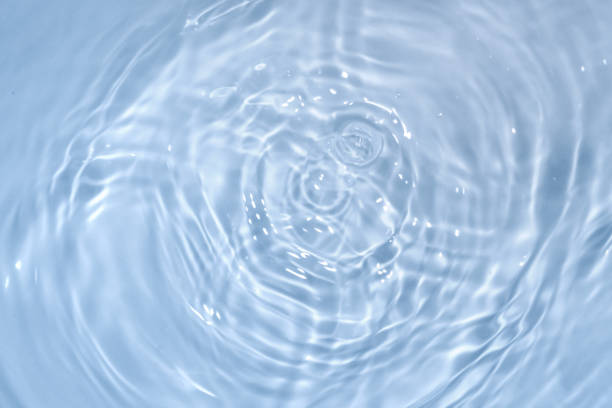 istock Circles on water. Blue round shadows. Blurred background made with water and light in monochrome. 1394154570
