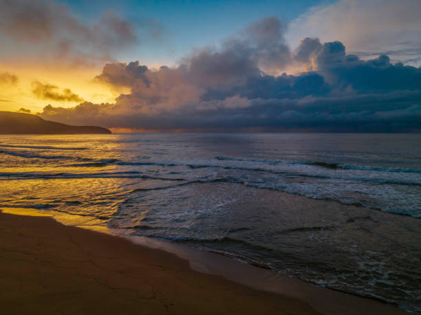 istock Sunrise seascape with rain clouds on the horizon 1394155423