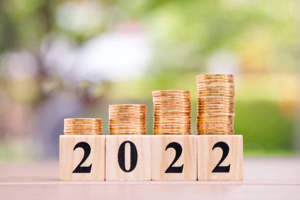 istock 2022 wood blocks number and growth of coins stack. 1394155429