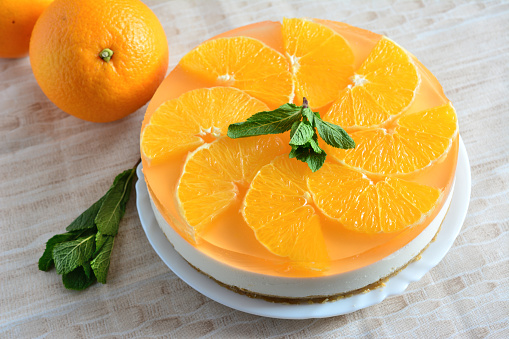 sugarfree cake decorated with oranges slices and mint, close-up