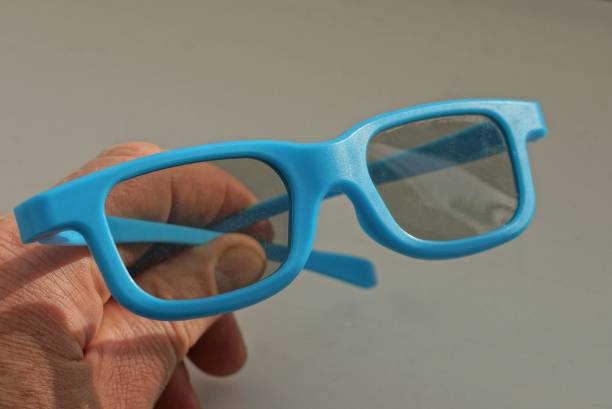 istock hand holds one blue plastic sunglasses 1394156942