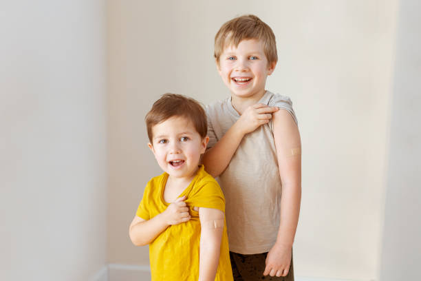istock Two little children after vaccination with adhesive plaster 1394157026