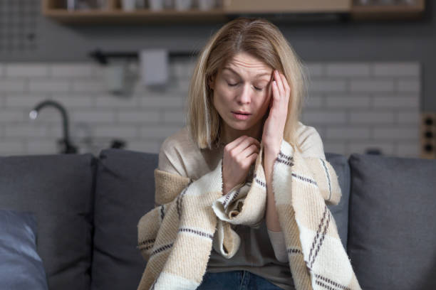 istock Sad woman at home sitting on sofa alone in depression crying 1394158746