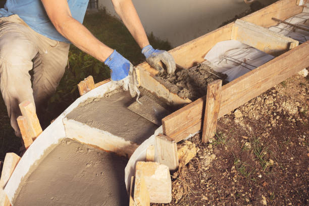 istock Man use trowel to fill formwork for concrete staircase 1394160312