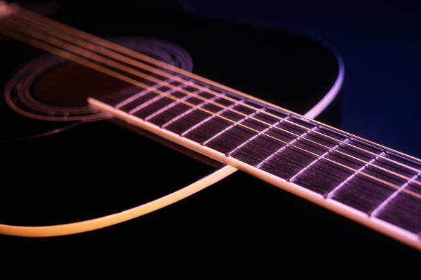 istock black guitar against a deep blue background. guitar music low-key concept 1394160406