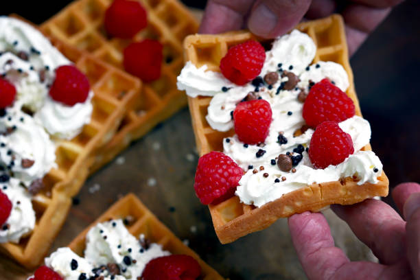 istock Soft focus. Macro. French waffles with cream and fresh raspberries. 1394161429