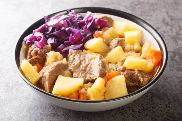 Scouse is a stew with meat and vegetables served with pickled cabbage close-up in a plate. Horizontal Scouse is a stew with meat and vegetables served with pickled cabbage close-up in a plate on the table. Horizontal pickled turnip stock pictures, royalty-free photos & images