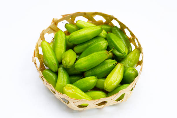 istock Bilimbi fruit in bamboo basket on white background. 1394163743