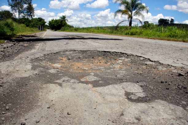 istock highway with damaged asphalt unsuitable for driving 1394164249