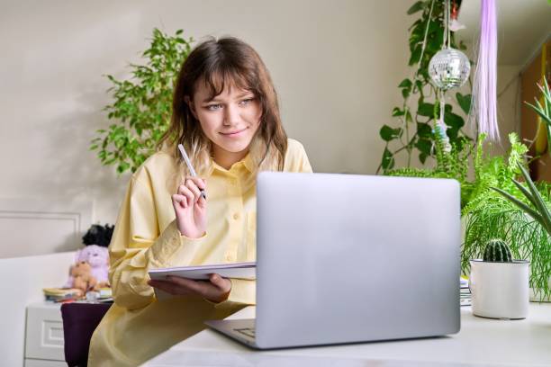istock Teenage female student studying at home using a laptop 1394164488