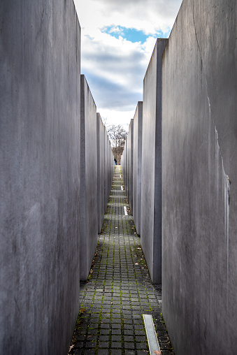 February 26, 2022 - Berlin, Germany:  The Memorial to the Murdered Jews of Europe, also known as the Holocaust Memorial, is a memorial in Berlin to the Jewish victims of the Holocaust, designed by architect Peter Eisenman and engineer Buro Happold. Building began on 1 April 2003, and was finished on 15 December 2004. It was inaugurated on 10 May 2005