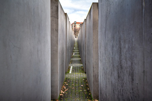 February 26, 2022 - Berlin, Germany:  The Memorial to the Murdered Jews of Europe, also known as the Holocaust Memorial, is a memorial in Berlin to the Jewish victims of the Holocaust, designed by architect Peter Eisenman and engineer Buro Happold. Building began on 1 April 2003, and was finished on 15 December 2004. It was inaugurated on 10 May 2005